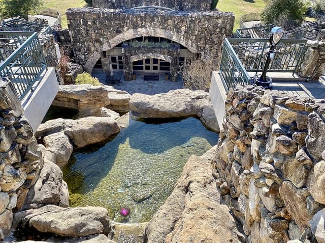 Exterior view of the spa area at Grove Park Inn with stone architecture and water features.