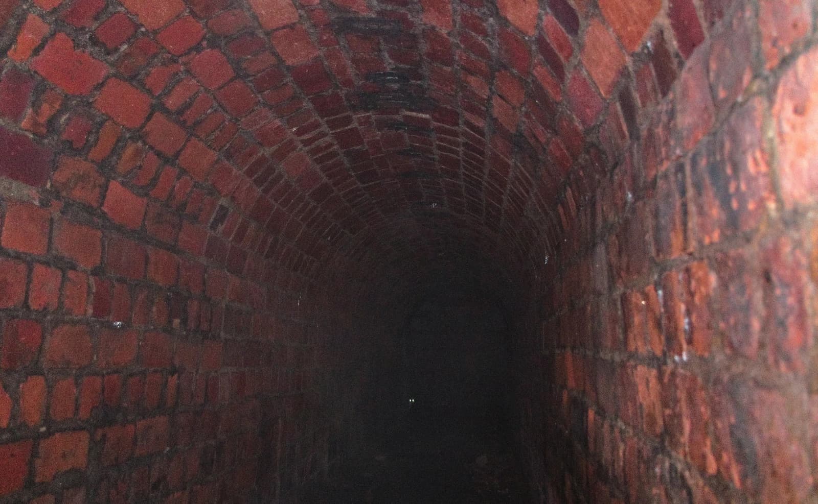 Interior of an arched brick air-raid shelter tunnel in Bytom, Poland.
