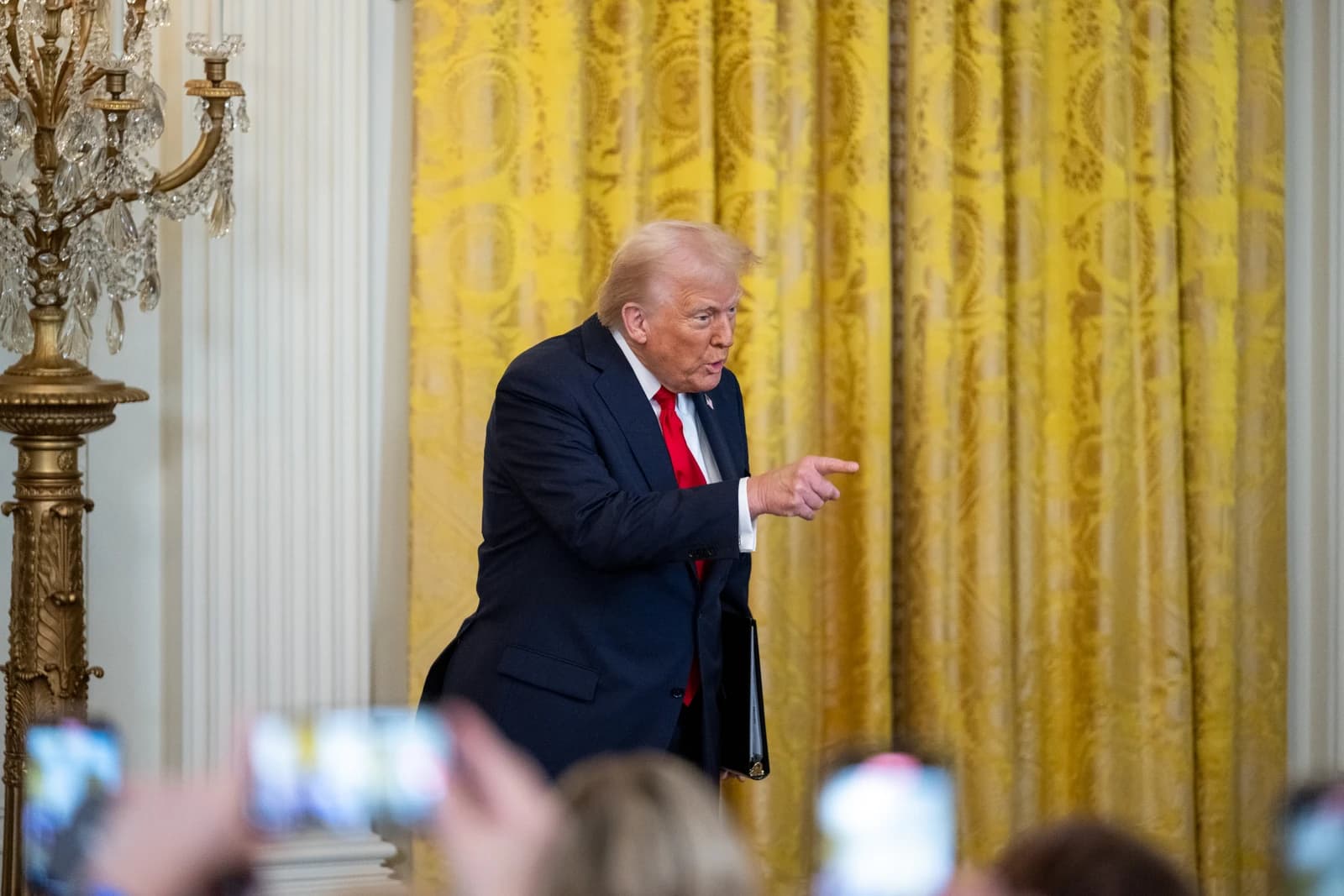 Donald Trump, former President of the United States, speaking and pointing inside a room.
