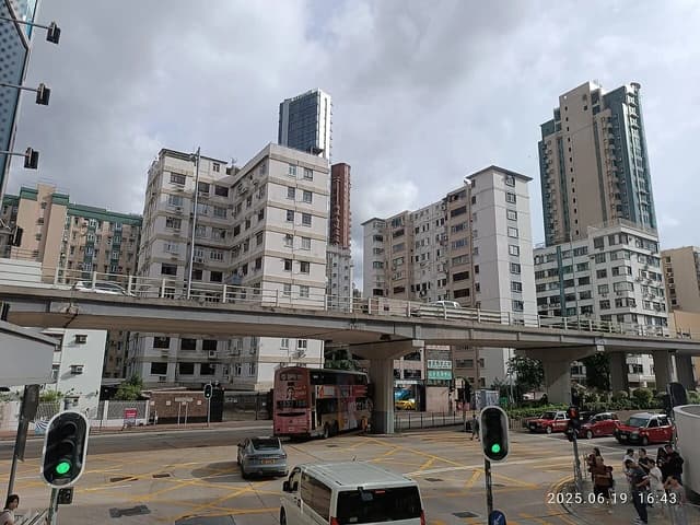 Residential buildings and an elevated road with traffic in Prince Edward Road West, Hong Kong.