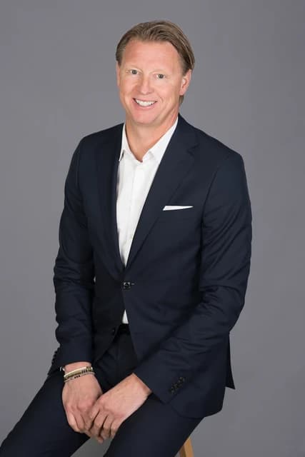 Hans Vestberg, CEO of Verizon, seated and smiling in a professional portrait.