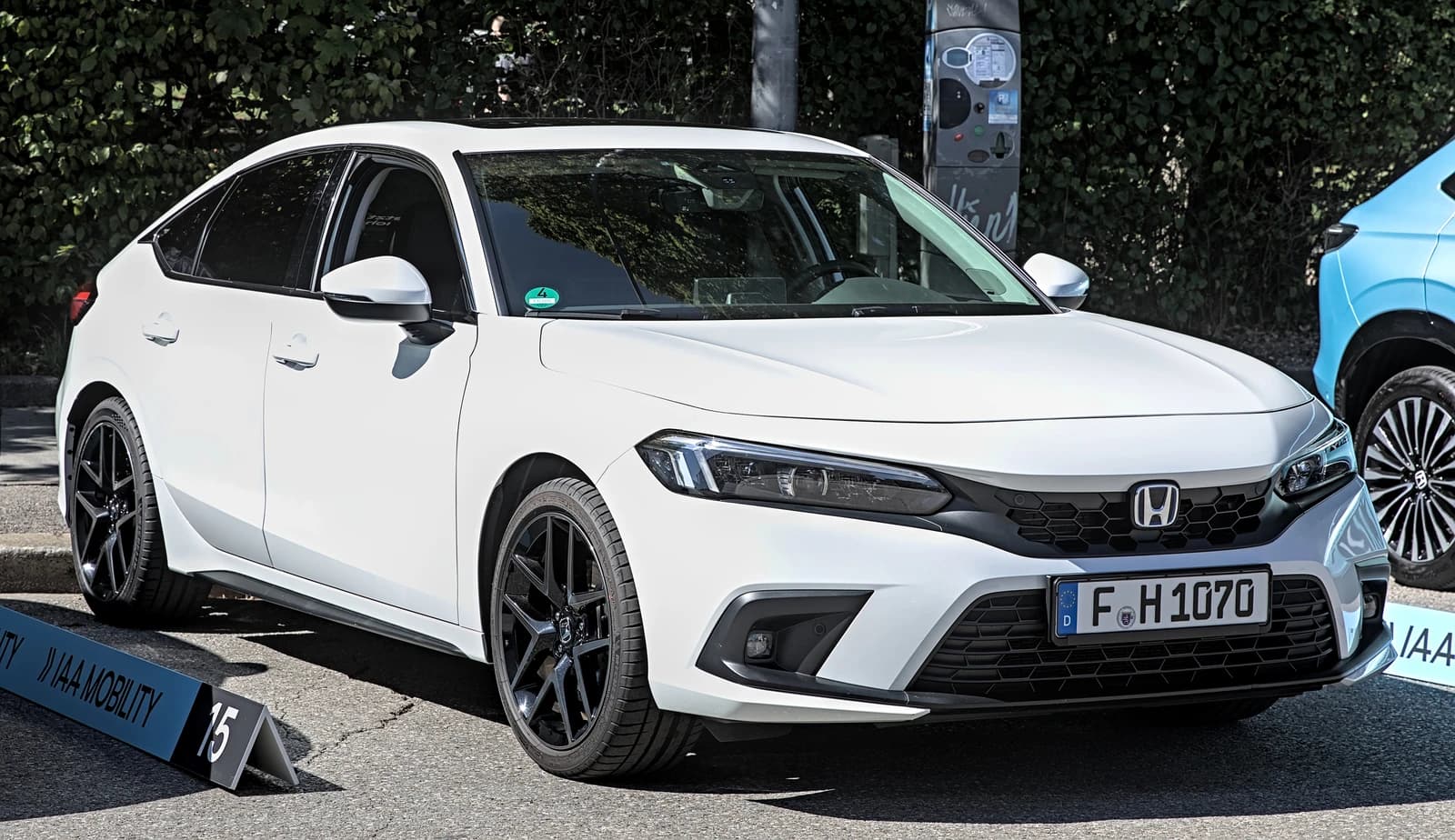 White 2022 Honda Civic Hybrid car parked outdoors, front three-quarter view.