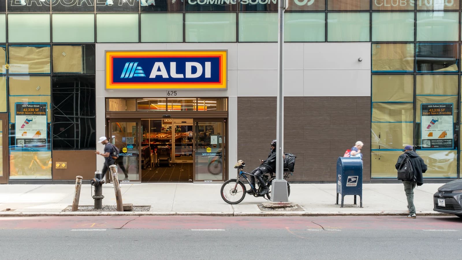 Exterior of an Aldi grocery store with its prominent blue and red logo.