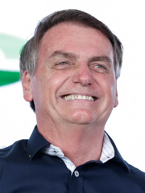 Jair Bolsonaro, former President of Brazil, smiling and looking up.