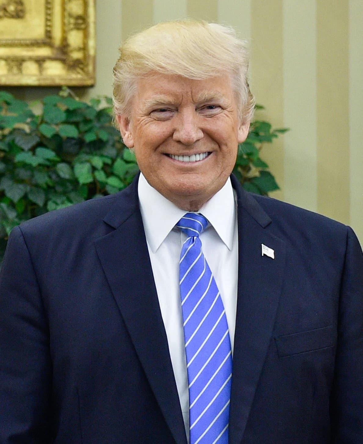 Donald Trump, former President, smiles in the Oval Office.