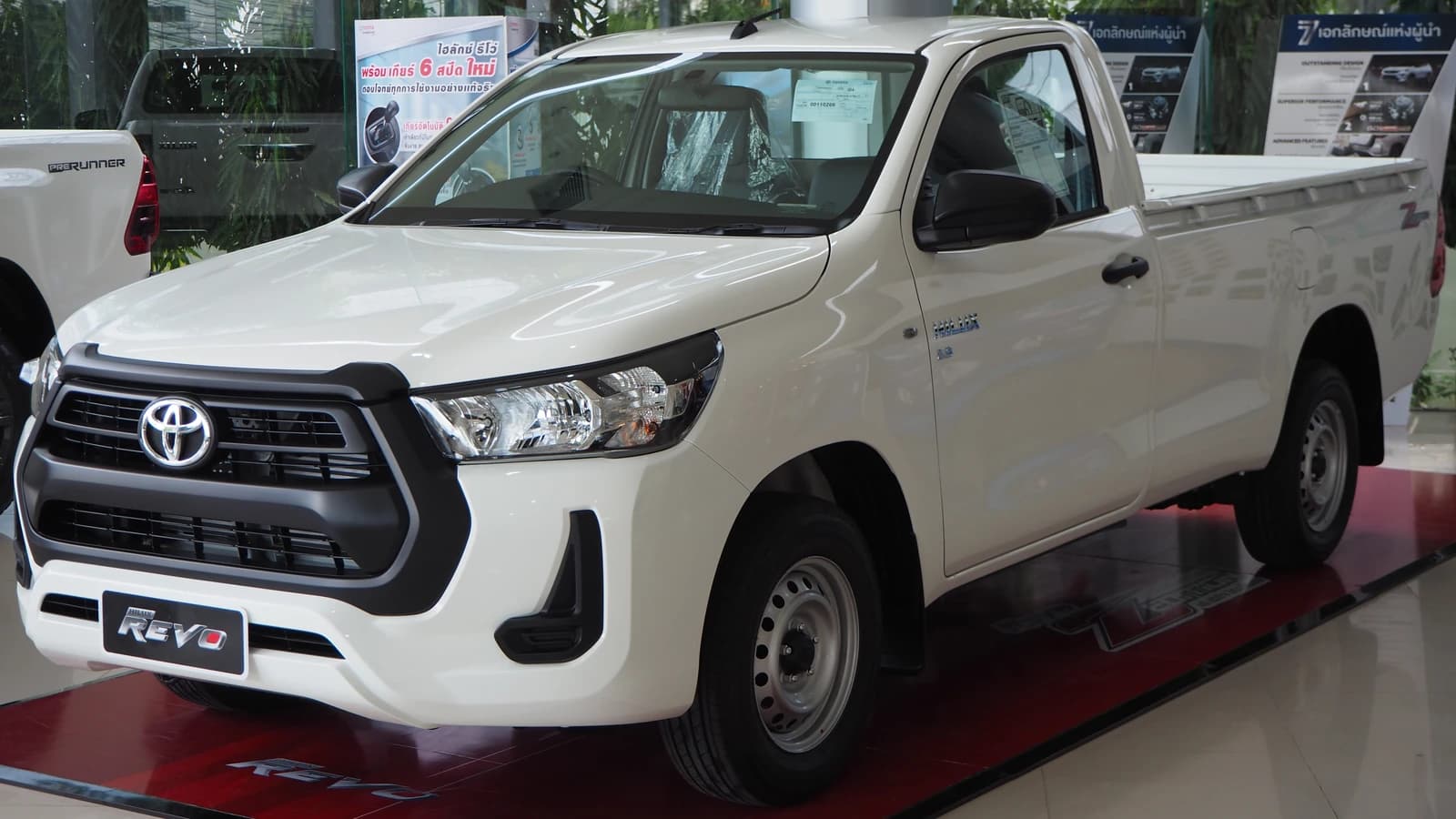 White Toyota Hilux Revo Single Cab pickup truck with black grille and wheels.