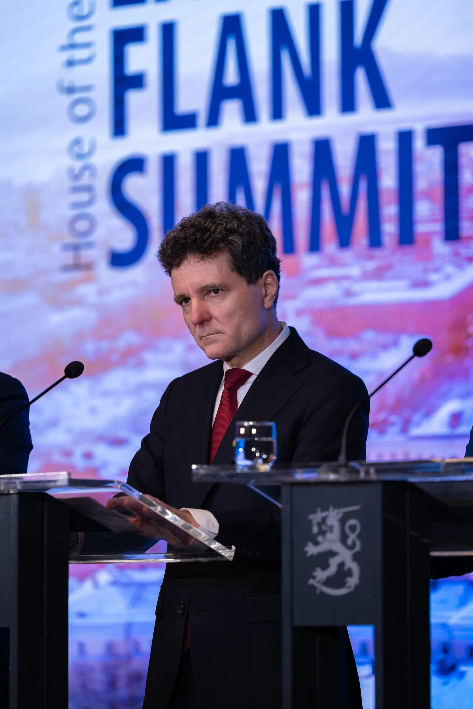 Nicușor Dan, president of Romania, stands at a podium during a summit.