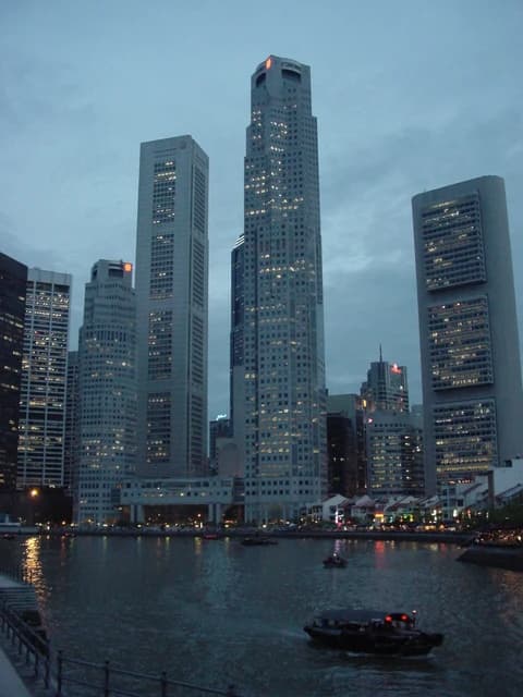 Evening view of UOB Plaza, OUB Centre, OCBC Centre near the Singapore River.