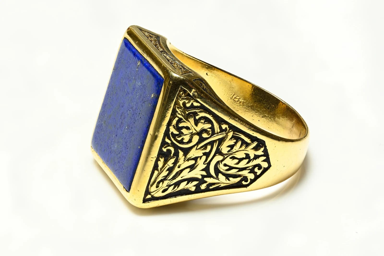 An antique gold ring with a rectangular blue lapis lazuli gemstone.