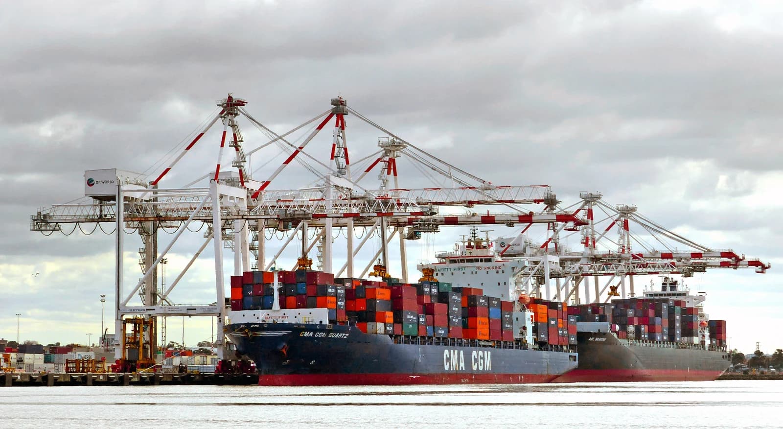 Cargo ships loaded with containers at a Port of Melbourne container terminal.
