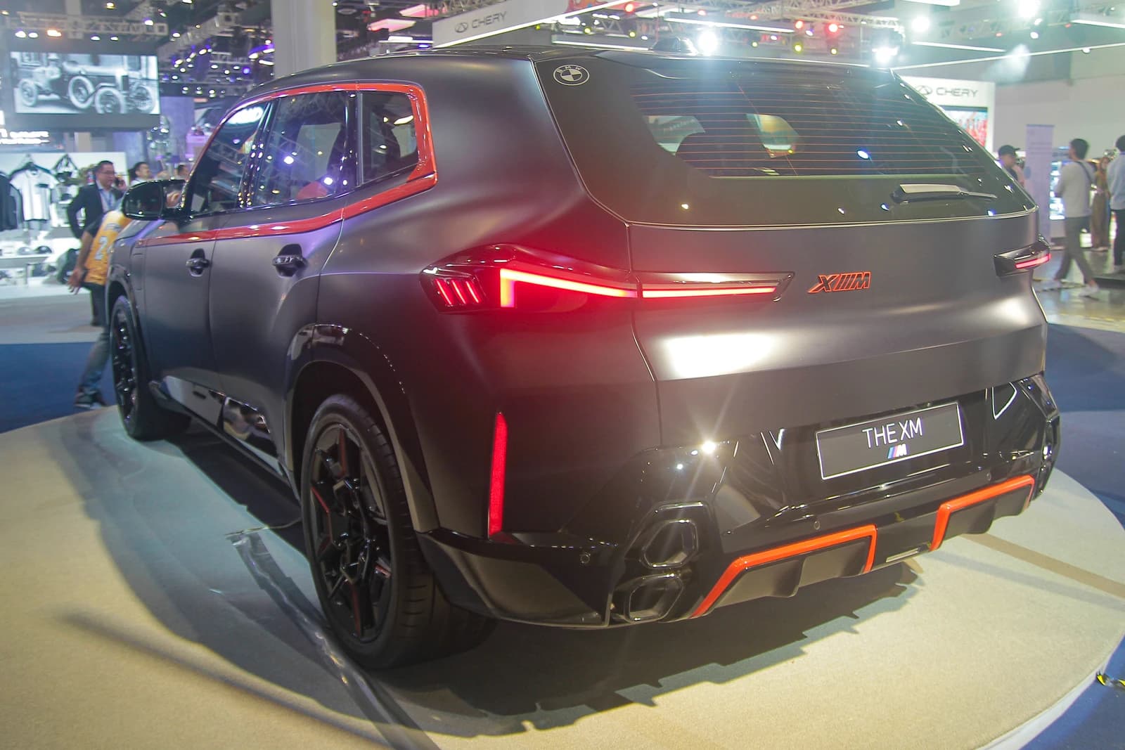 Rear view of the new BMW XM Label Red SUV on display at an auto show.