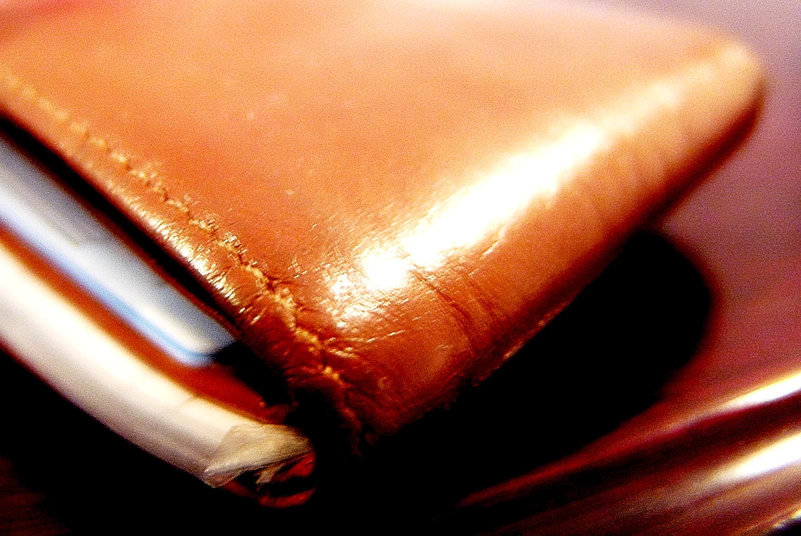 Close-up of a brown leather wallet with the edge of cards showing.