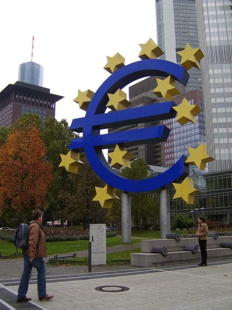 Giant blue Euro sign sculpture with yellow stars in Frankfurt, Germany.