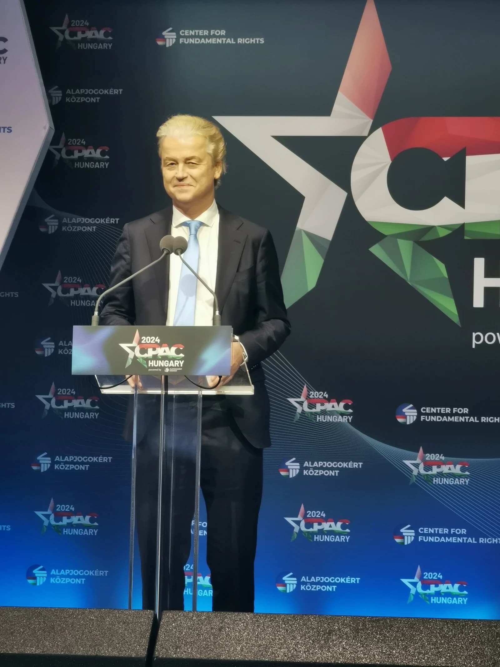 Geert Wilders, Dutch politician, speaking at a podium in front of a backdrop.