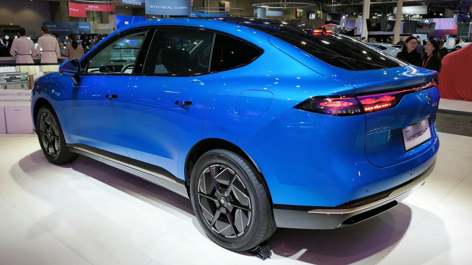Blue GAC Aion Hyptec HT car shown from the rear three-quarter view at an exhibition.