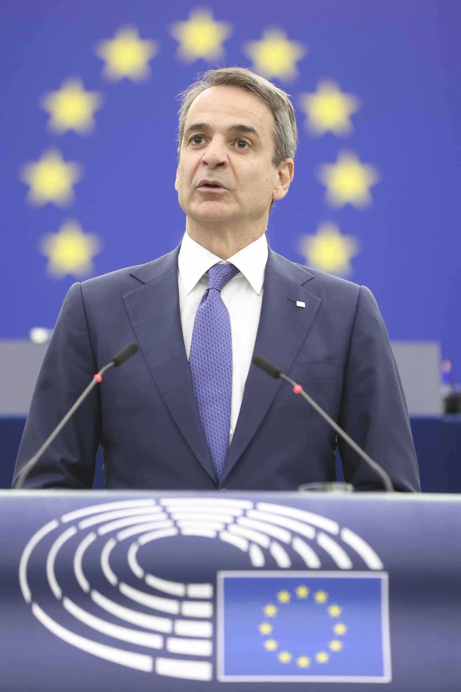 Kyriakos Mitsotakis, Prime Minister of Greece, speaking at a podium in the European Parliament.