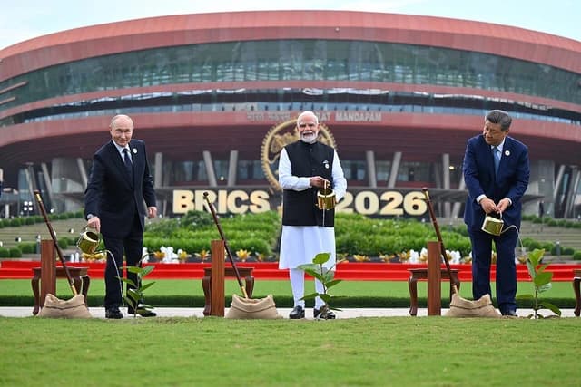 Vladimir Putin, Narendra Modi, and Xi Jinping watering newly planted trees at an outdoor ceremony.
