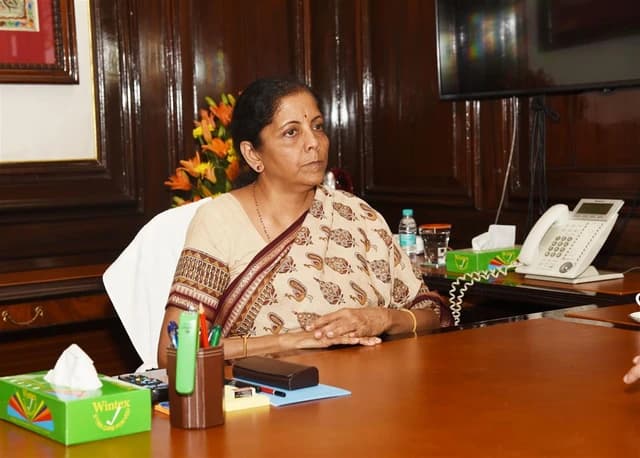 Nirmala Sitharaman, Union Minister for Finance and Corporate Affairs, sitting at a desk in New Delhi.