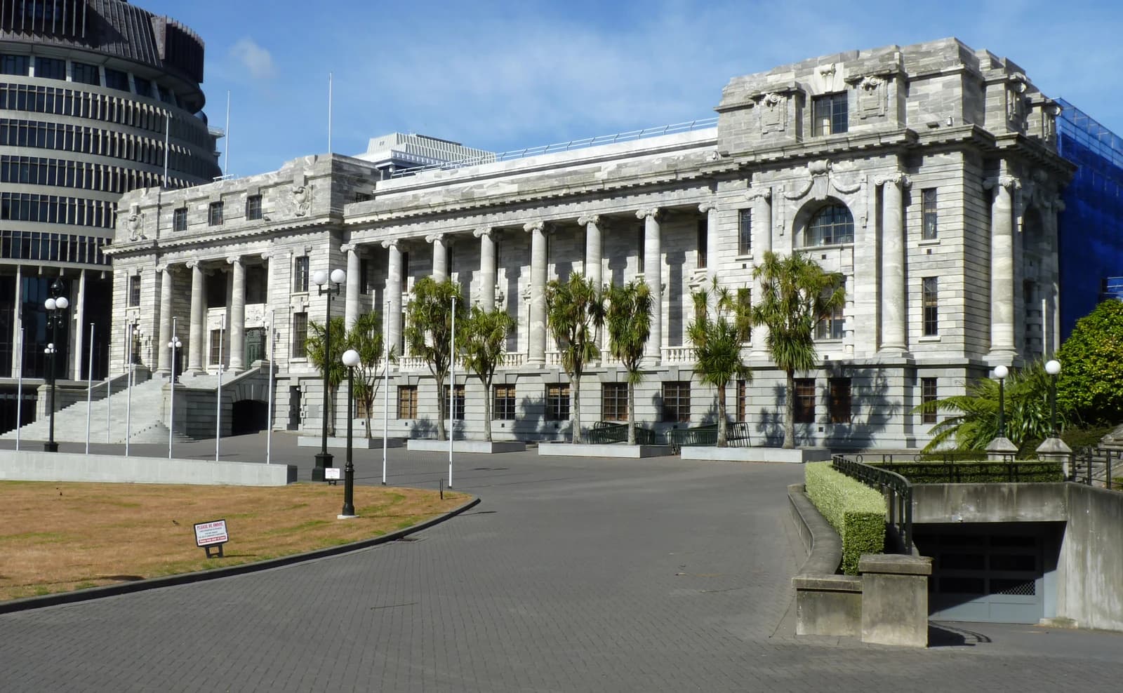 Exterior view of the Parliament House complex in Wellington, New Zealand, under a blue sky.