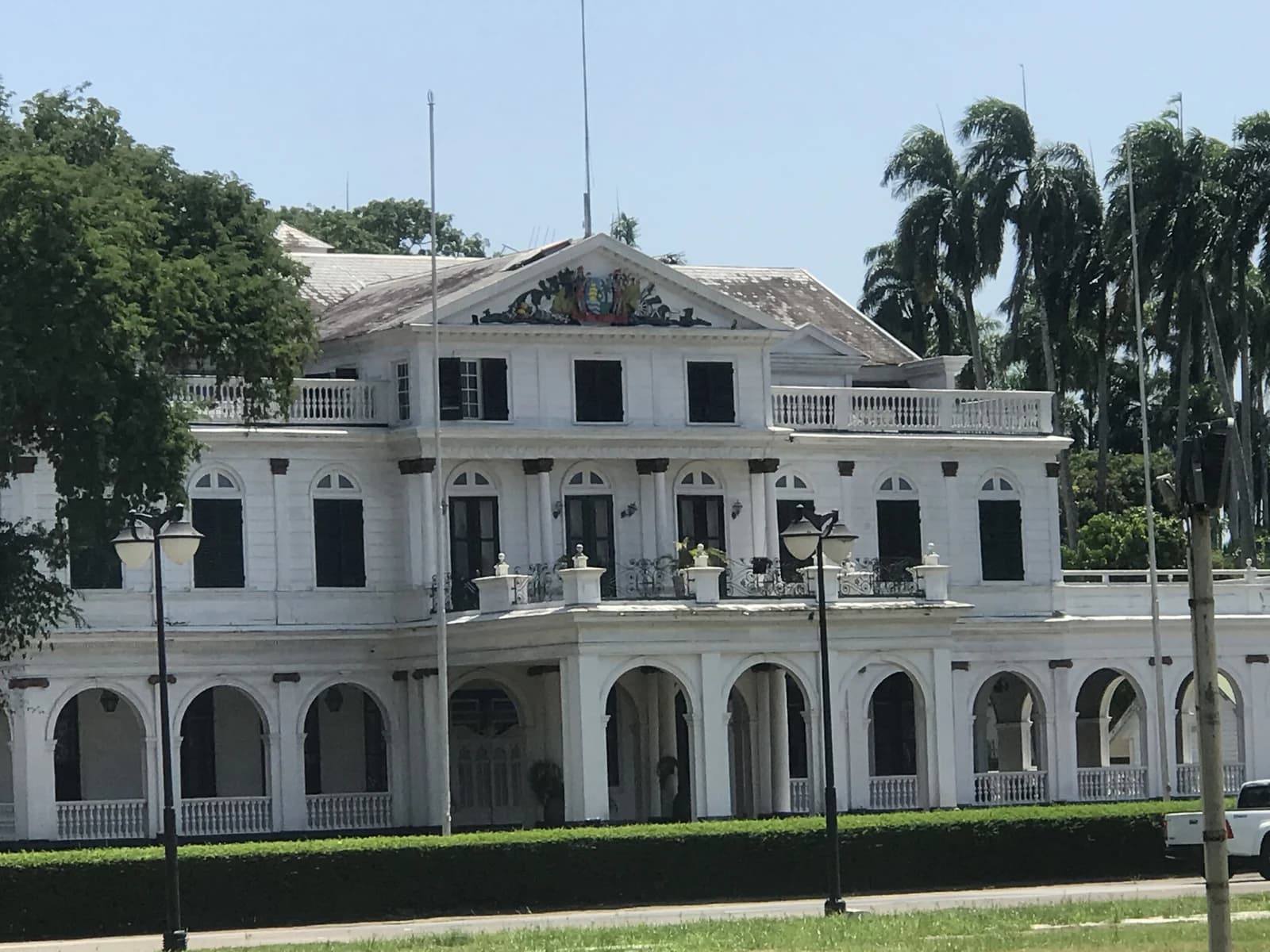 Presidential Palace of the Republic of Suriname, a white colonial building with arches and balconies.