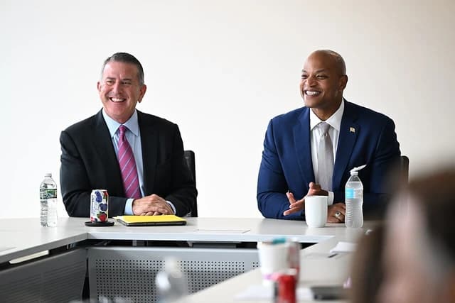 Target Corporation CEO and a man in a blue suit smiling at a fireside chat event.