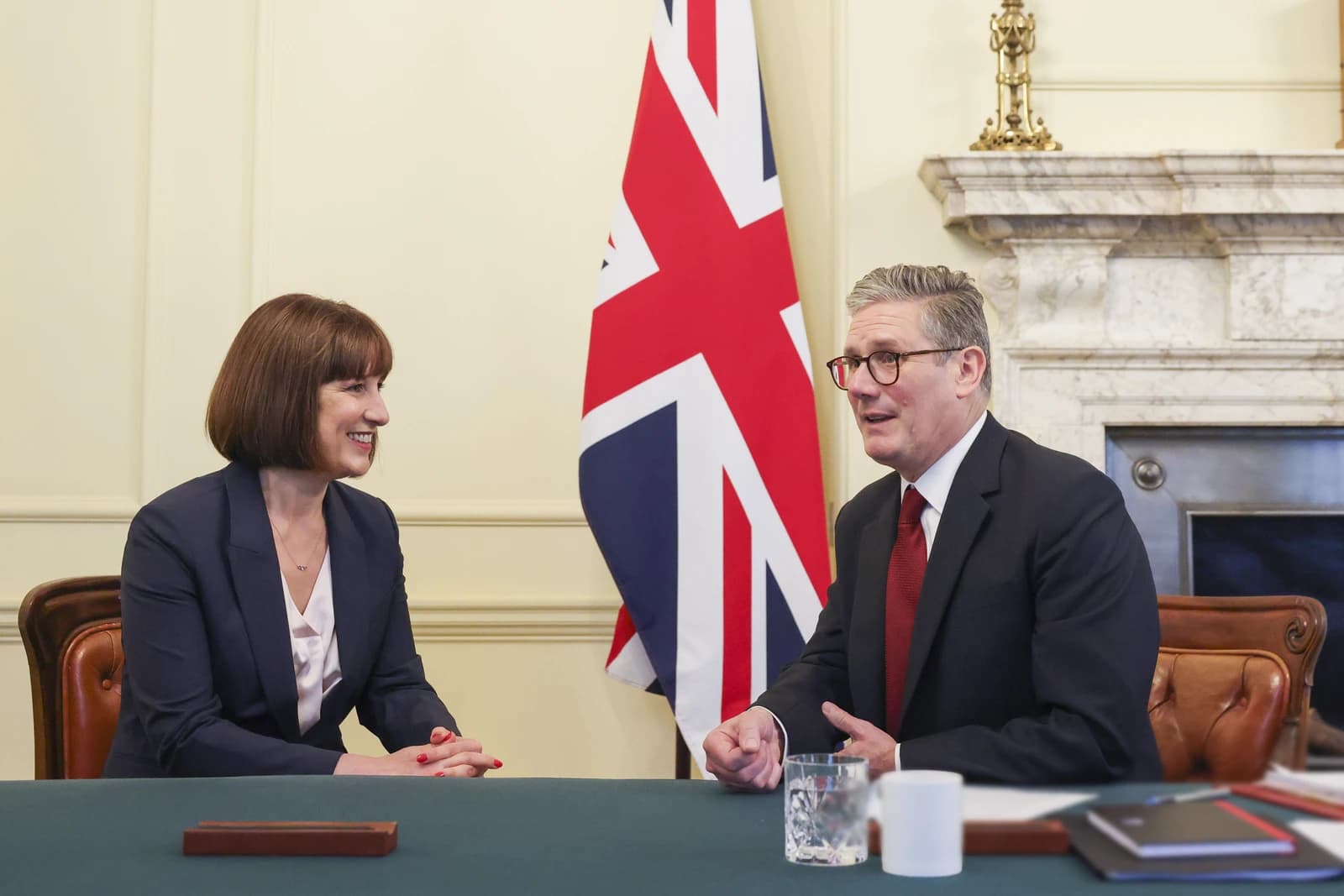Rachel Reeves, Shadow Chancellor of the Exchequer, sitting at a table with Keir Starmer.