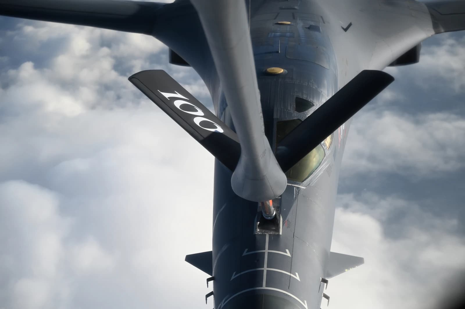 A B-1 Lancer bomber aircraft receives fuel from another aircraft during flight.