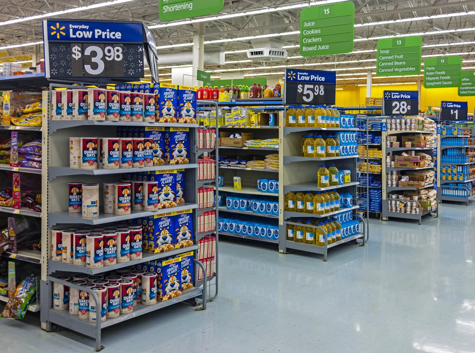 A long view of a Walmart grocery store aisle with various products on shelves.