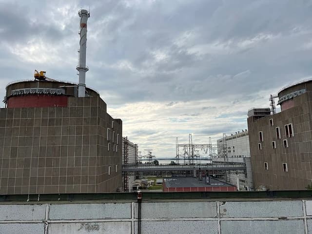 Exterior view of Zaporizhzhia Nuclear Power Plant under a cloudy sky.