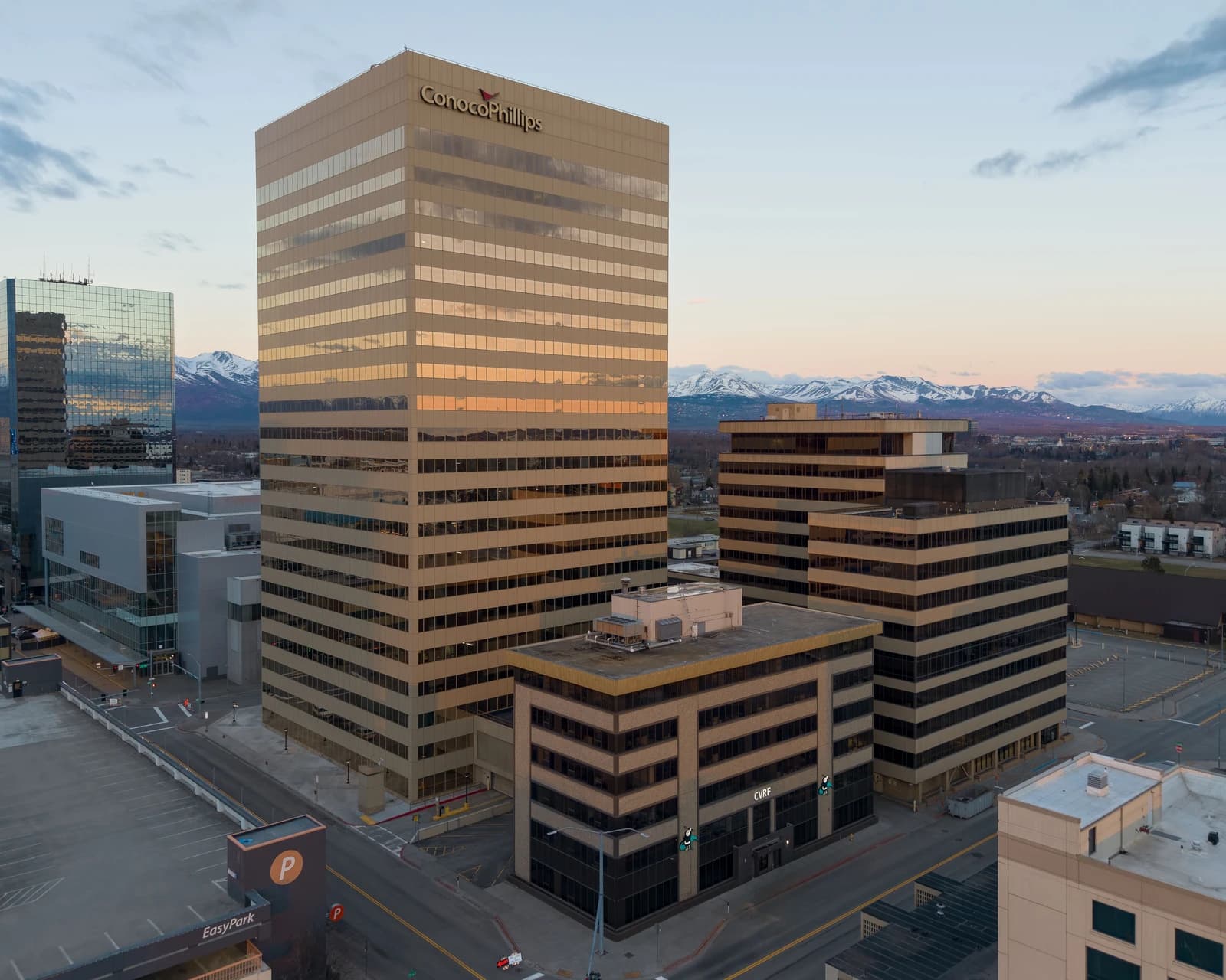 ConocoPhillips building in Anchorage, Alaska, stands against a mountain backdrop.