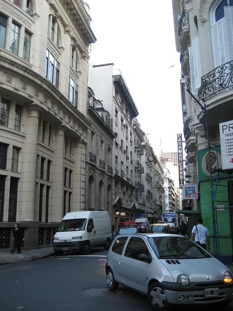 Street in Microcentro, Buenos Aires, with historical buildings and vehicle traffic.