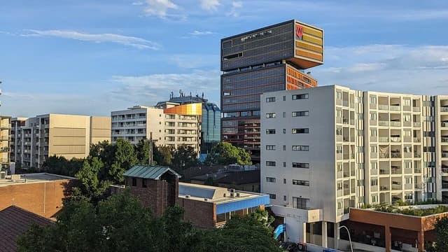 Skyline of Bankstown with residential buildings and a distinct modern commercial building.