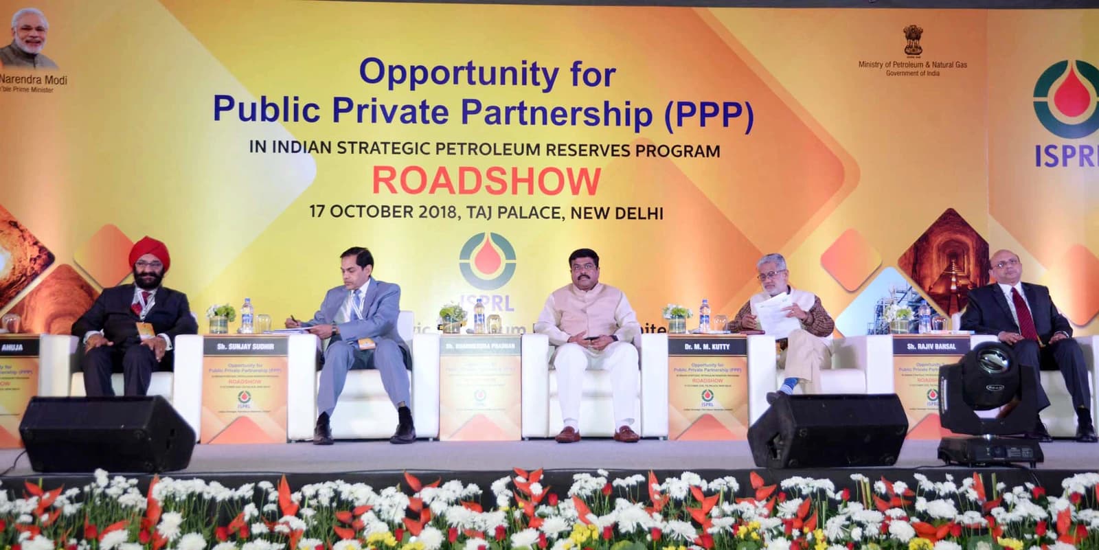 Dharmendra Pradhan, Union Minister for Petroleum & Natural Gas, seated at a conference table.