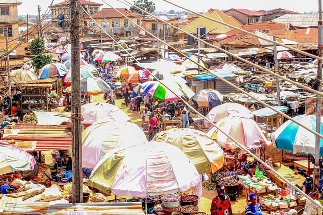 IWORO MARKET DAY in Ikorodu, Lagos State, Nigeria, with many market stalls and people.