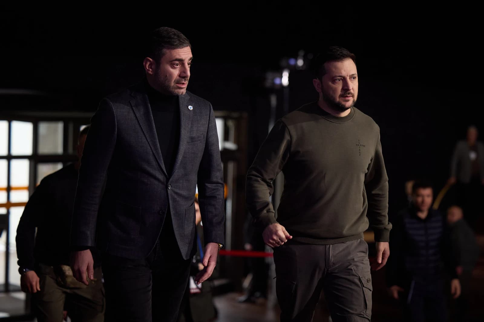 Ukrainian President Volodymyr Zelenskyy and another man walking together.