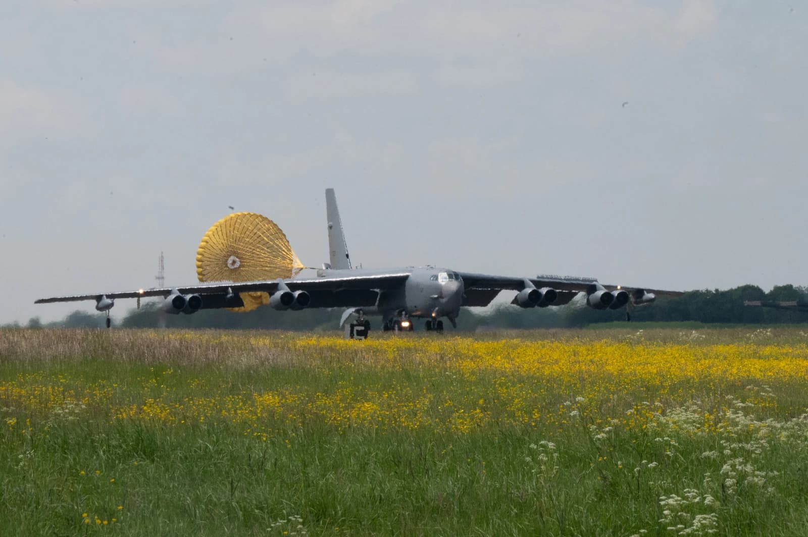 B-52 Stratofortress bomber landing at RAF Fairford with a deployed drag parachute.