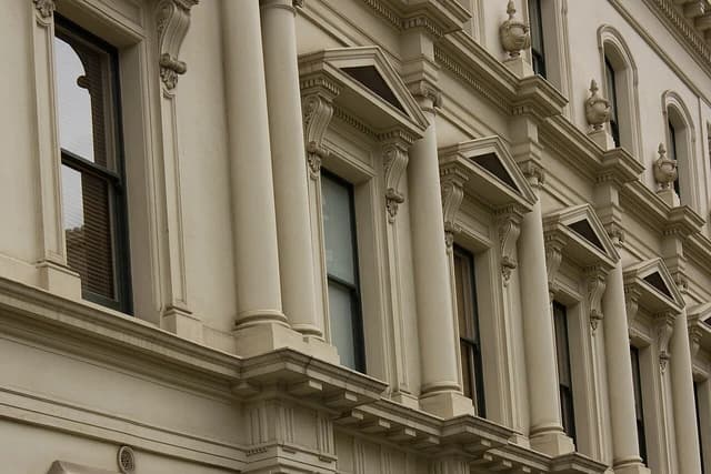 Exterior architectural detail of 2 Treasury Place, featuring windows and columns.