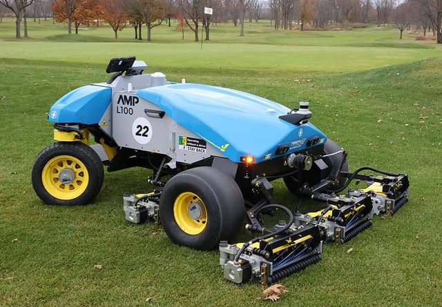 FireFly Automatix AMP-L100 autonomous electric reel mower on a green lawn.