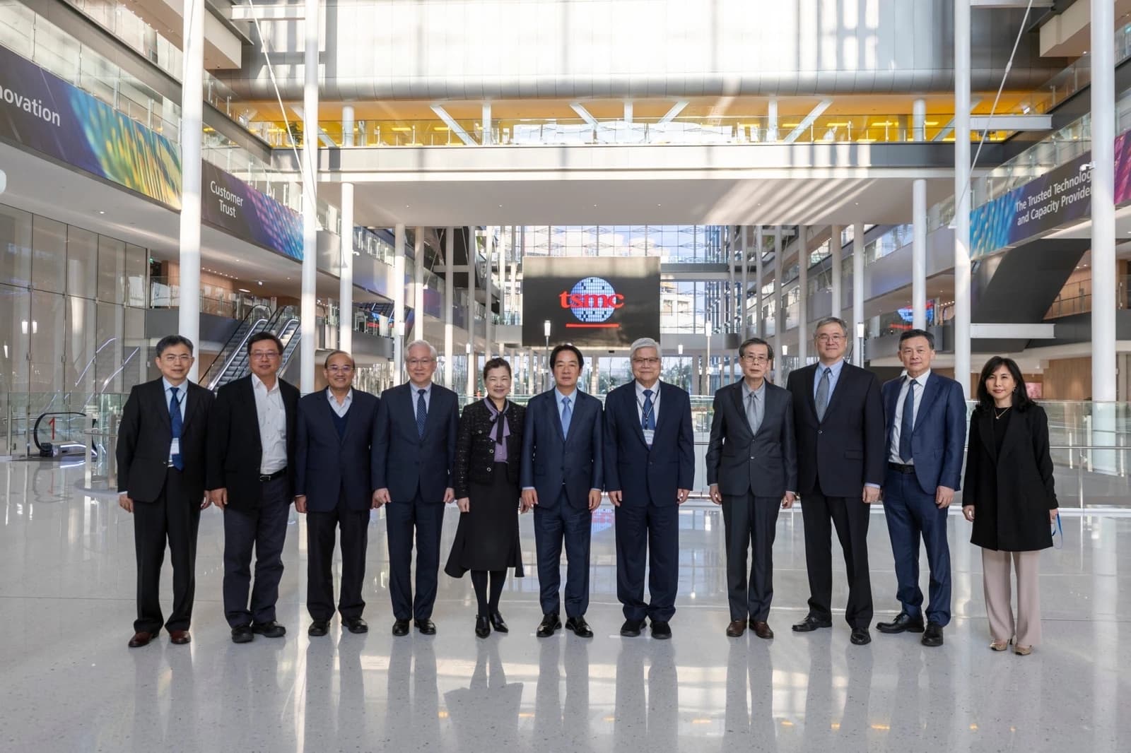 Group of executives, including TSMC representatives, standing in the Global R&D Center.