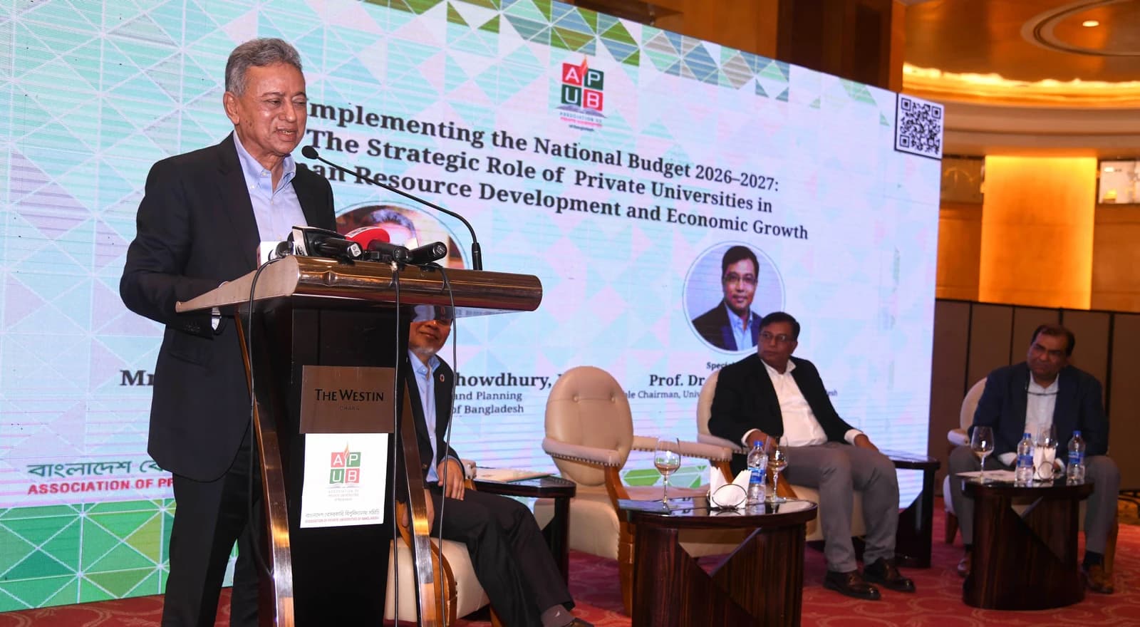 Amir Khasru Mahmud Chowdhury speaking at a podium during a discussion meeting.