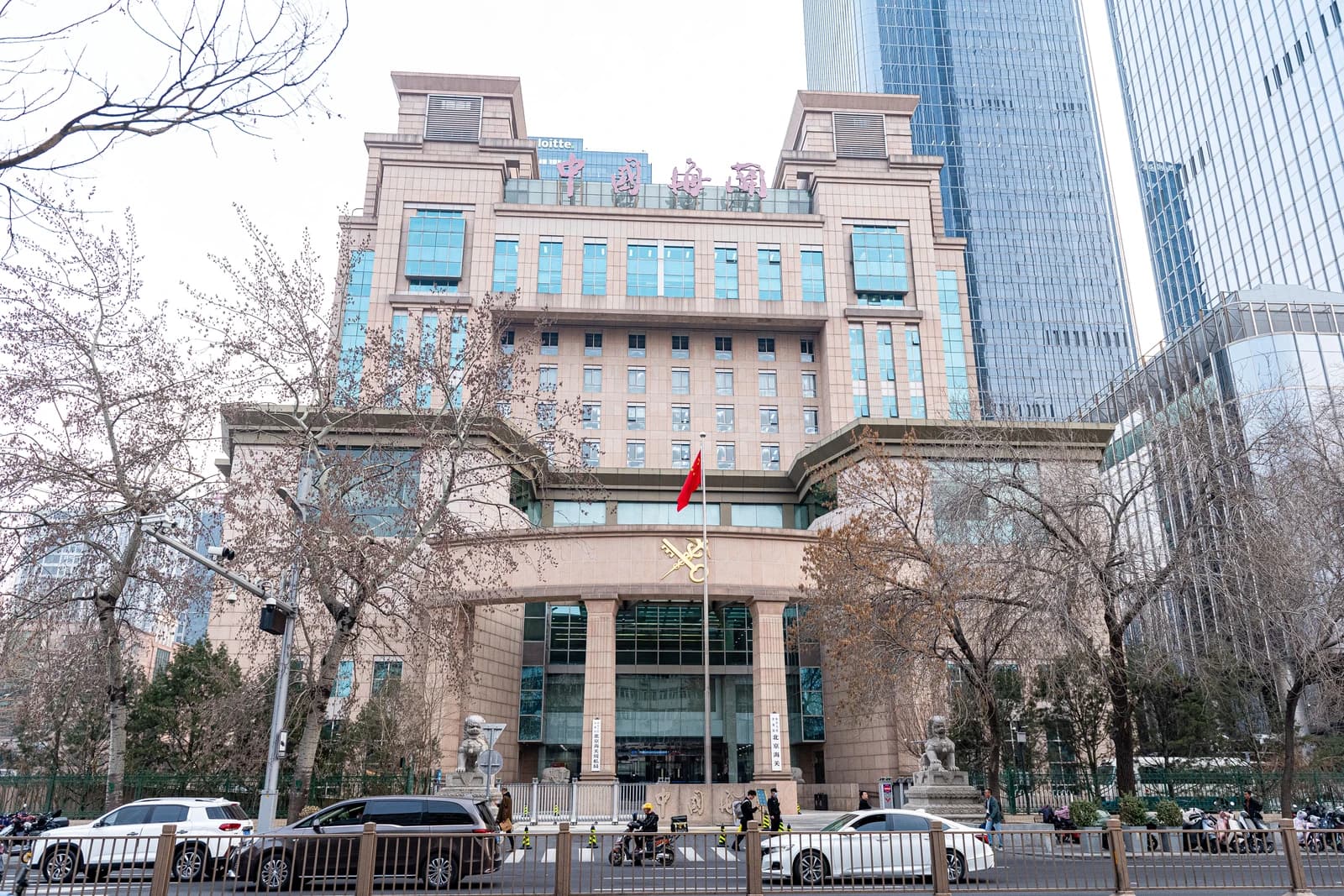 Beijing Customs Building, a multi-story stone building with a Chinese flag flying out front.
