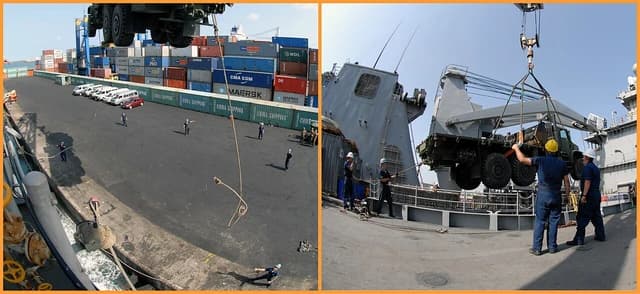 Port workers moving equipment and guiding a large vehicle being unloaded at a harbor.
