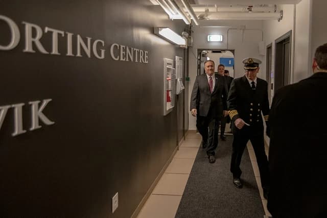 Secretary of State Mike Pompeo walks through a hallway at Keflavik Airbase, Iceland.