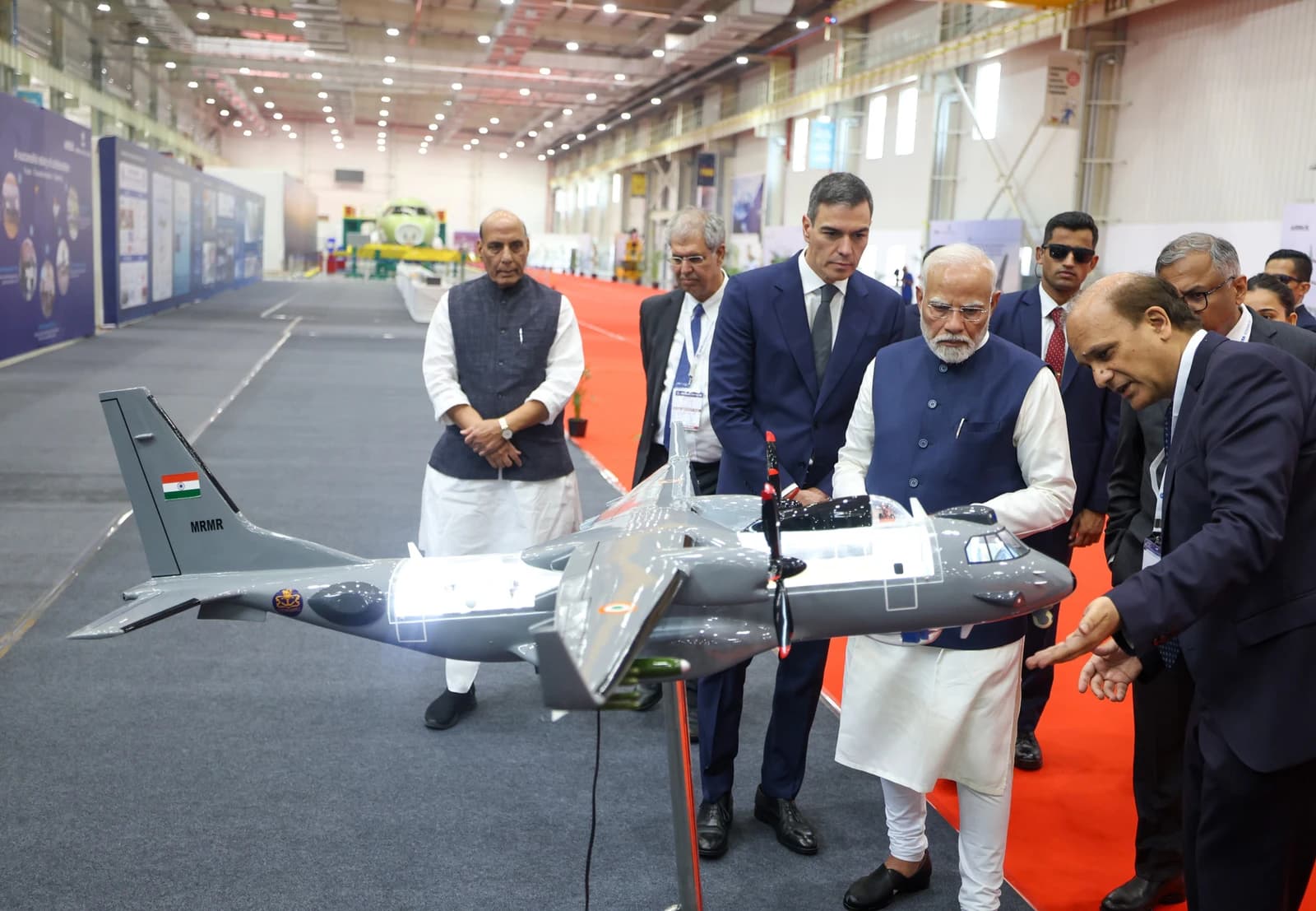 Prime Minister Narendra Modi and Prime Minister Pedro Sanchez inspect an aircraft model.