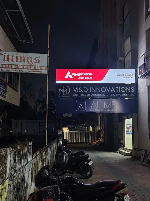 Axis Bank Loan Centre sign, other signs, and parked motorbikes at night.