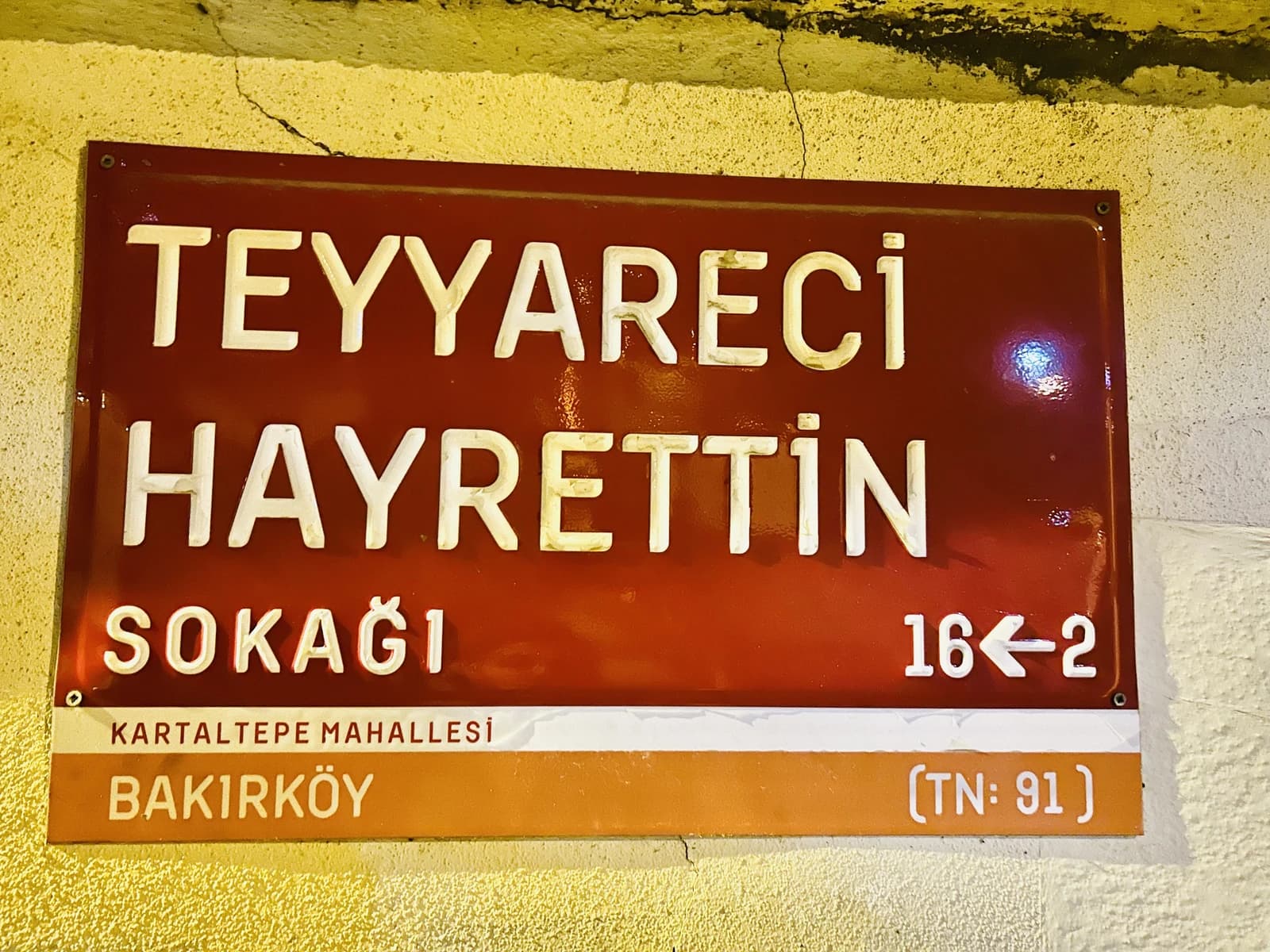 Street sign indicating Teyyareci Hayrettin Street, Kartaltepe Mahallesi, Bakırköy.