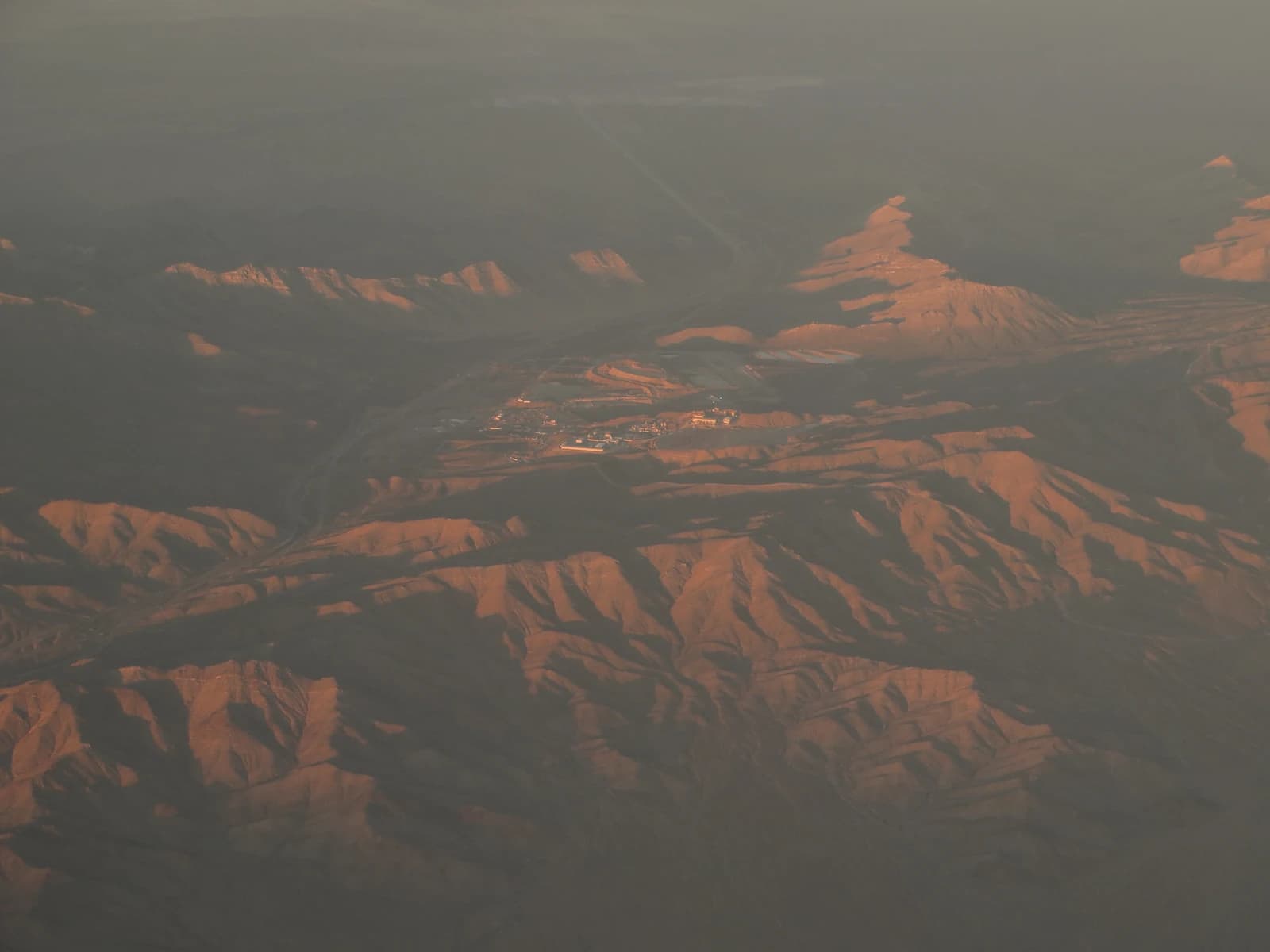 Aerial view of Mountain Pass Rare Earth Mine surrounded by mountains.
