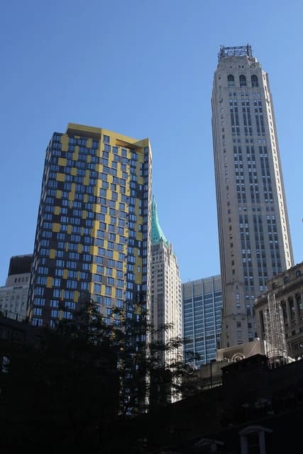 Skyscrapers with distinctive architectural styles dominate the Financial District skyline in New York City.