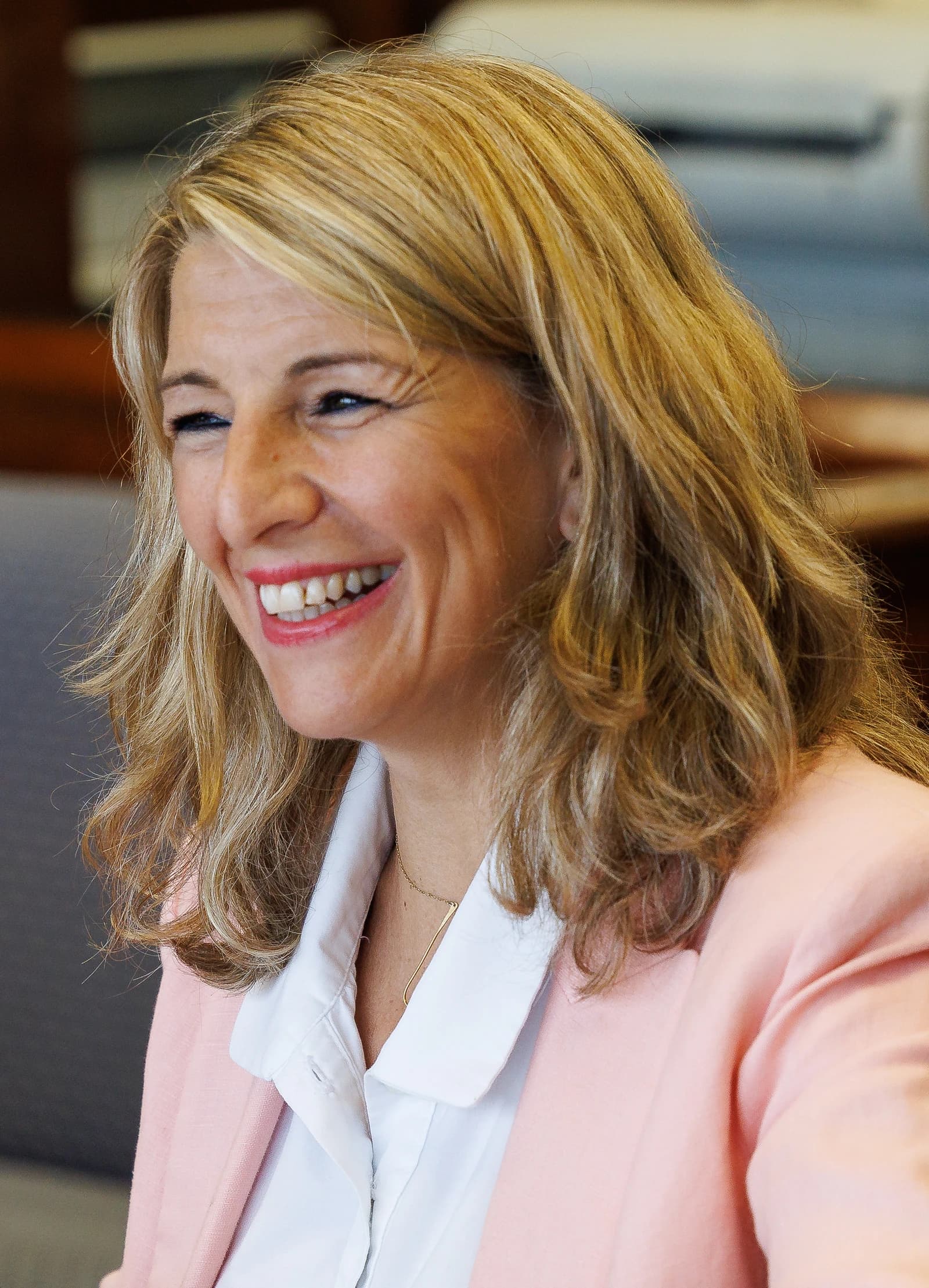 Yolanda Díaz Pérez, Spanish Minister of Labour, smiling broadly indoors.