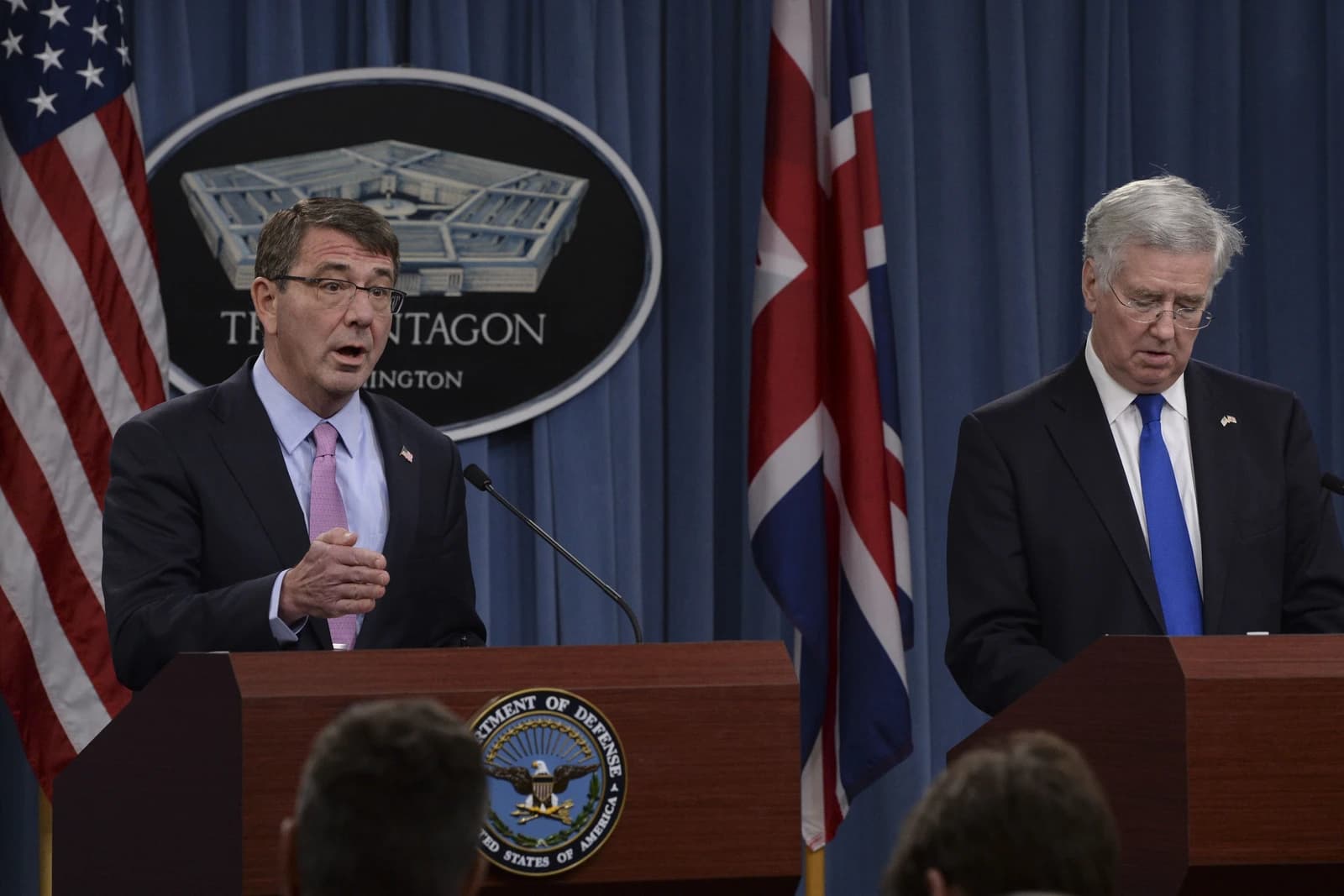 Ash Carter, US Secretary of Defense, speaks at a podium next to Michael Fallon, UK Secretary of State for Defence.